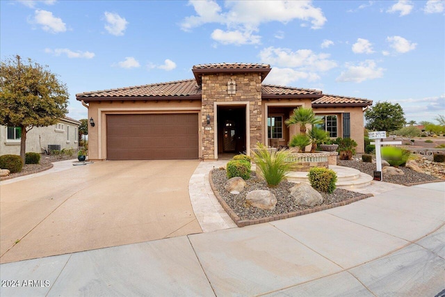 mediterranean / spanish house with a garage