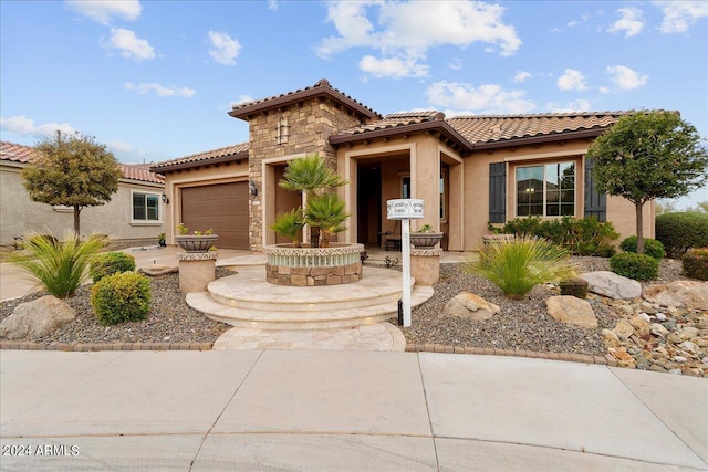 mediterranean / spanish home featuring a garage