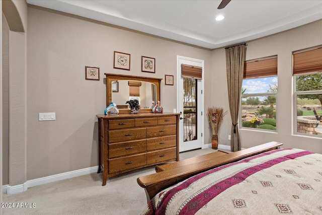 bedroom featuring light colored carpet, access to exterior, and ceiling fan