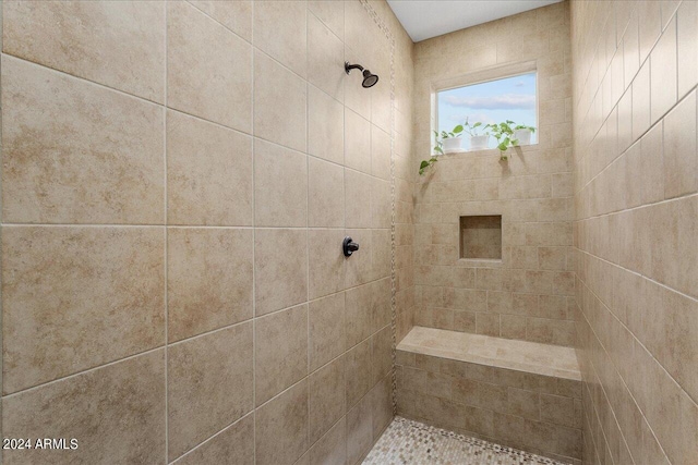 bathroom featuring tiled shower