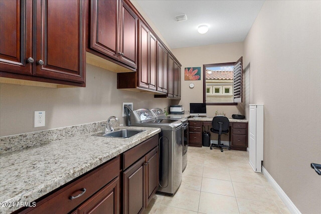 washroom featuring cabinets, washer and clothes dryer, sink, and light tile patterned floors