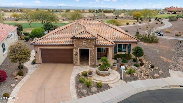 mediterranean / spanish-style home with a garage