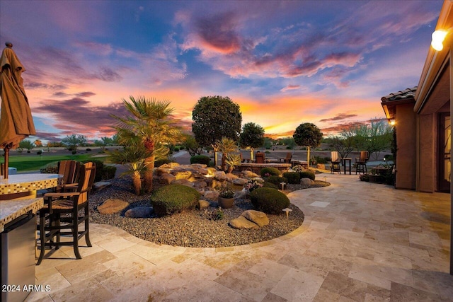 view of patio terrace at dusk