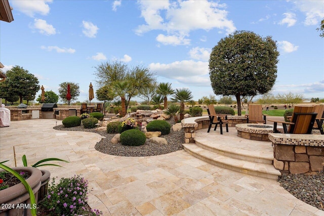 view of patio / terrace featuring a grill and an outdoor fire pit