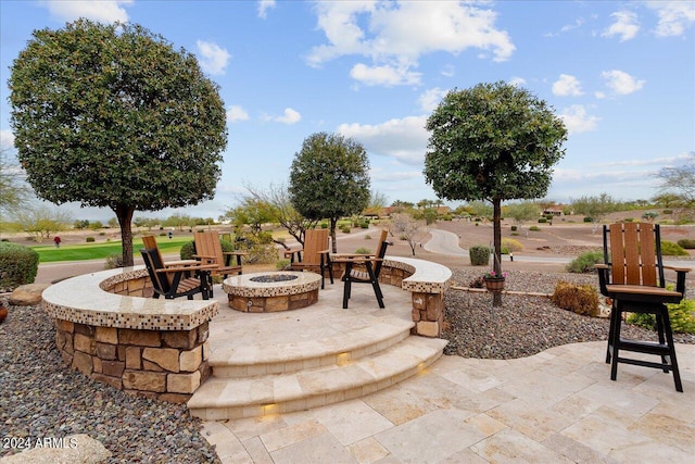 view of patio / terrace with an outdoor fire pit