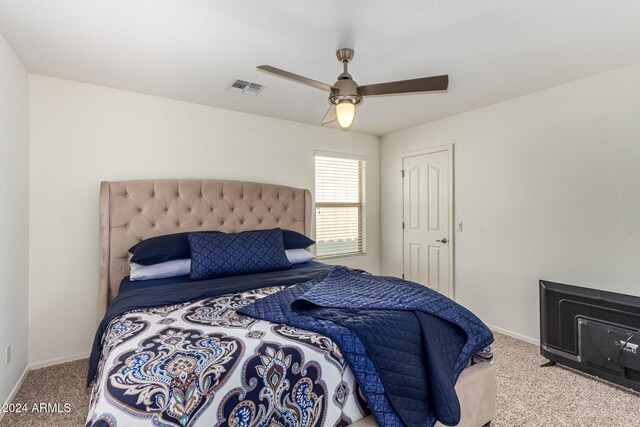 carpeted bedroom featuring ceiling fan and a closet