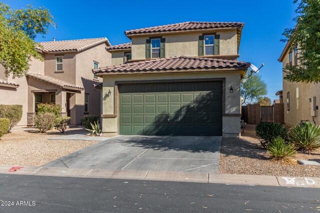 mediterranean / spanish house featuring a garage