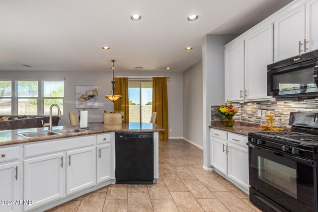 kitchen featuring sink, white cabinetry, a healthy amount of sunlight, and black appliances