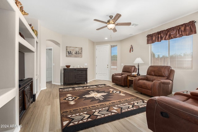 living room featuring ceiling fan and light hardwood / wood-style floors