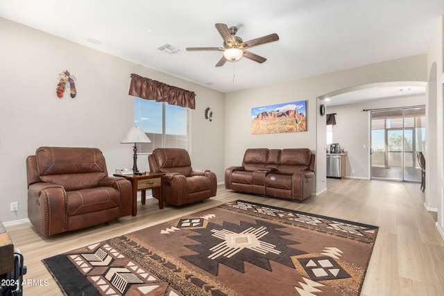 living room with ceiling fan and light wood-type flooring