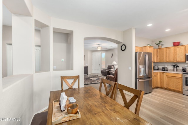 dining area featuring ceiling fan and light wood-type flooring