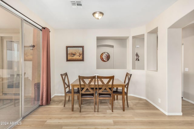 dining space featuring light wood-type flooring