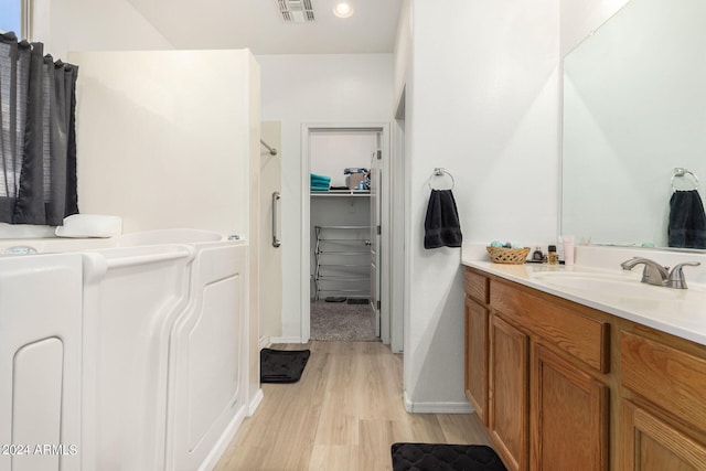 bathroom with vanity and wood-type flooring