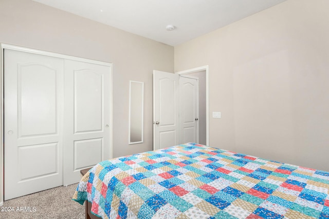 bedroom with light colored carpet and a closet