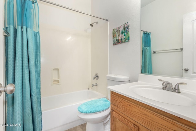 full bathroom featuring toilet, shower / tub combo with curtain, and vanity