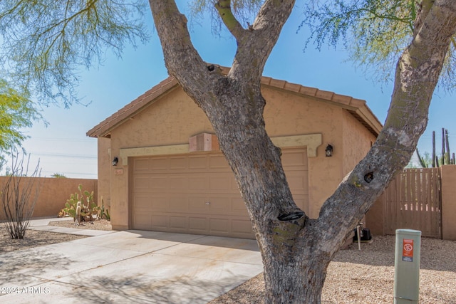 view of front of house featuring a garage and an outbuilding