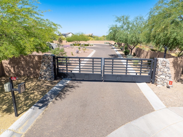 view of gate with a fenced front yard