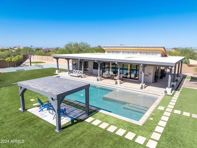 rear view of house featuring a fenced in pool, a patio area, fence, and a lawn