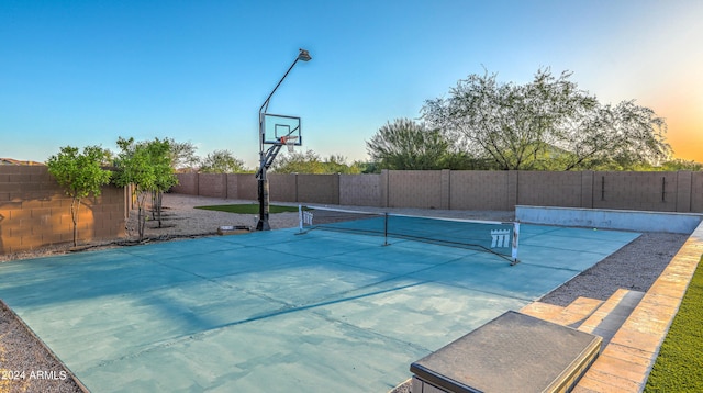 view of sport court featuring fence and basketball court