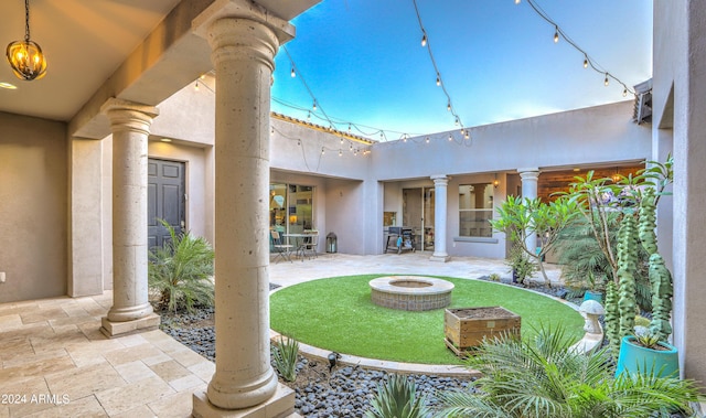 exterior space with an outdoor fire pit and a patio