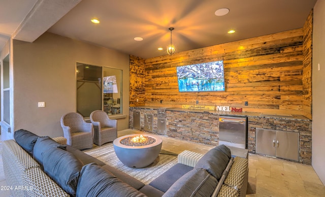 living area with wood walls, stone tile flooring, and recessed lighting