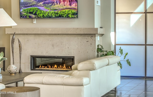 living area with a tiled fireplace