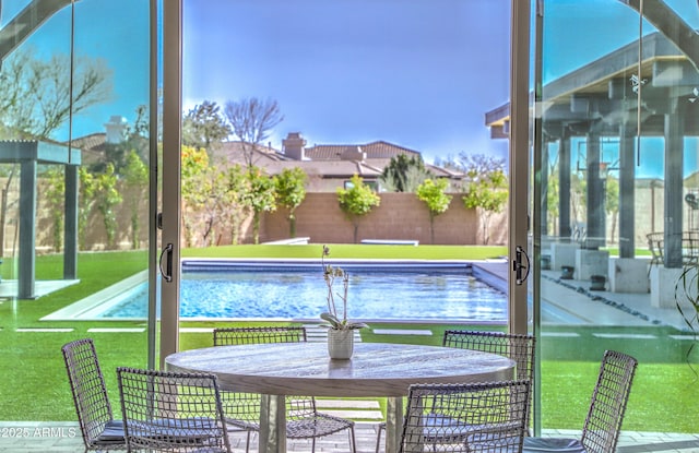 view of swimming pool with fence and a lawn