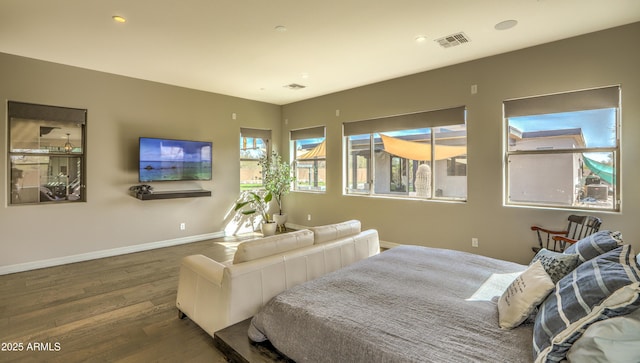 bedroom with recessed lighting, wood finished floors, visible vents, and baseboards