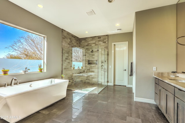 full bathroom with a freestanding tub, recessed lighting, vanity, baseboards, and a stall shower