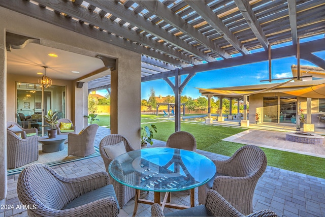 view of patio with a fire pit, outdoor dining area, and a pergola