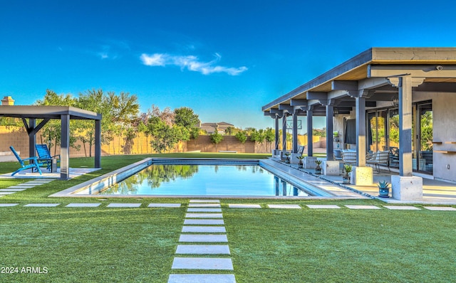 view of swimming pool featuring a patio area, a fenced backyard, a fenced in pool, and a lawn