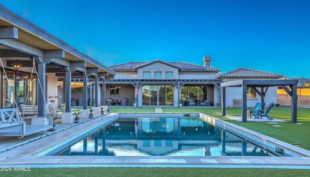 pool featuring a patio area and a lawn