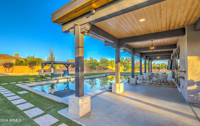 view of swimming pool with a patio area, fence, and a fenced in pool