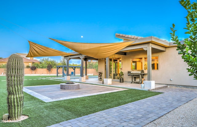 exterior space featuring an outdoor fire pit, a pergola, fence, and stucco siding