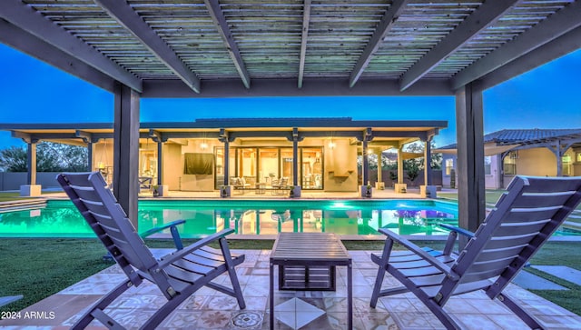 view of swimming pool featuring a patio area, a fenced in pool, and a pergola