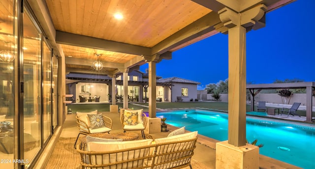 pool at night with a patio area, fence, an outdoor living space, and a fenced in pool