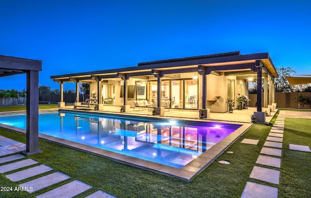 view of swimming pool with a fenced in pool, fence, a lawn, and a patio