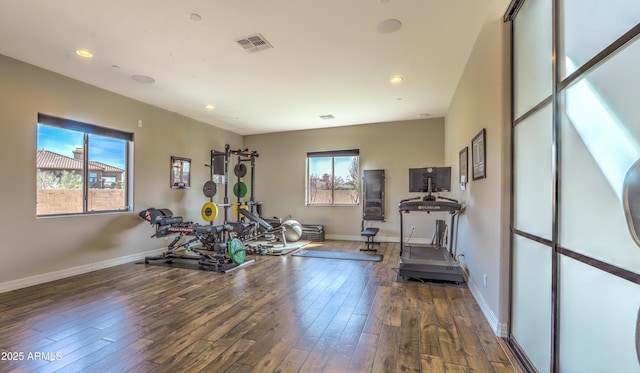 exercise room with wood-type flooring, visible vents, baseboards, and recessed lighting