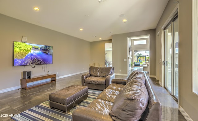 living area featuring baseboards and recessed lighting