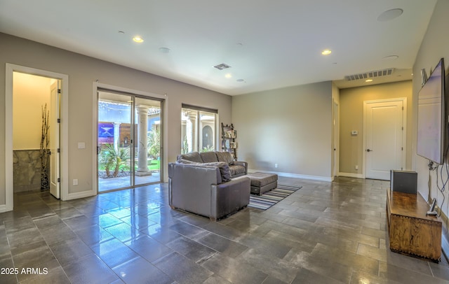 living area with recessed lighting, visible vents, and baseboards