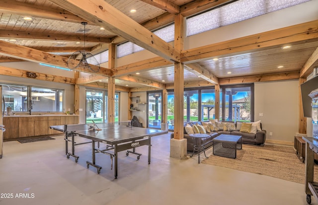 dining room featuring lofted ceiling with beams, wood ceiling, finished concrete floors, and a wealth of natural light