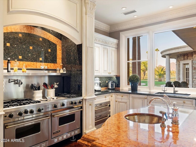 40 Biltmore Est, Phoenix, AZ 85016 - kitchen featuring double oven range, visible vents, backsplash, and a sink