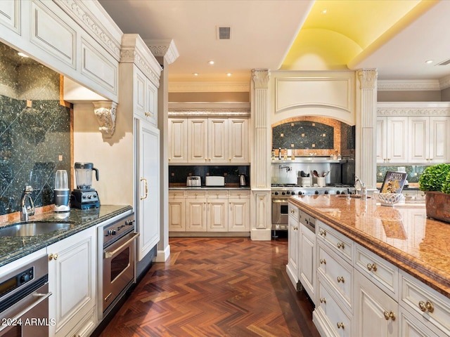 40 Biltmore Est, Phoenix, AZ 85016 - kitchen with visible vents, a sink, tasteful backsplash, dark stone counters, and appliances with stainless steel finishes