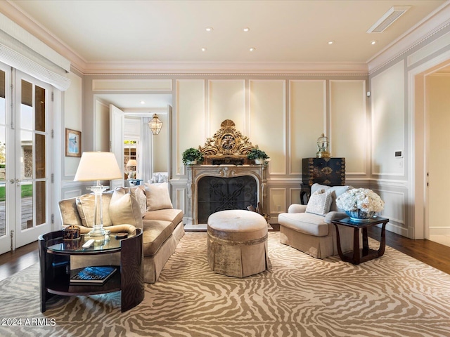 40 Biltmore Est, Phoenix, AZ 85016 - living area with wood finished floors, visible vents, a fireplace, ornamental molding, and a decorative wall
