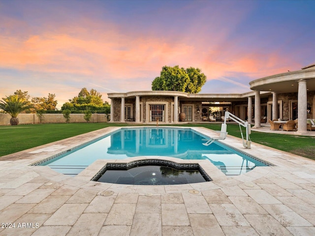 40 Biltmore Est, Phoenix, AZ 85016 - pool at dusk featuring a patio, a lawn, fence, and a pool with connected hot tub