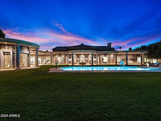 40 Biltmore Est, Phoenix, AZ 85016 - pool at dusk featuring a patio, a lawn, and an outdoor pool