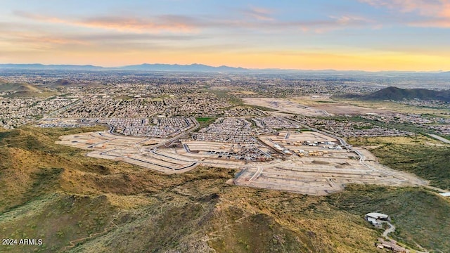 aerial view at dusk featuring a mountain view