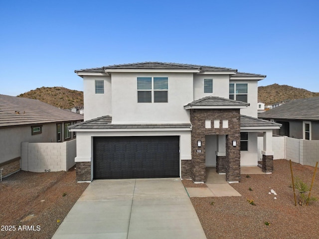 view of front of property featuring a garage and a mountain view