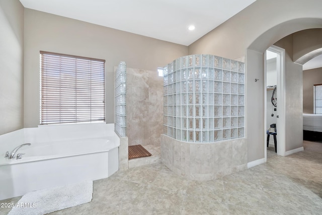 bathroom featuring independent shower and bath