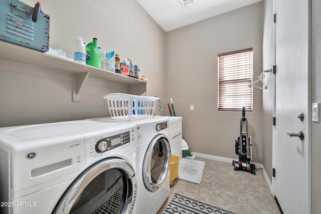 laundry area featuring washer and clothes dryer and light tile patterned flooring